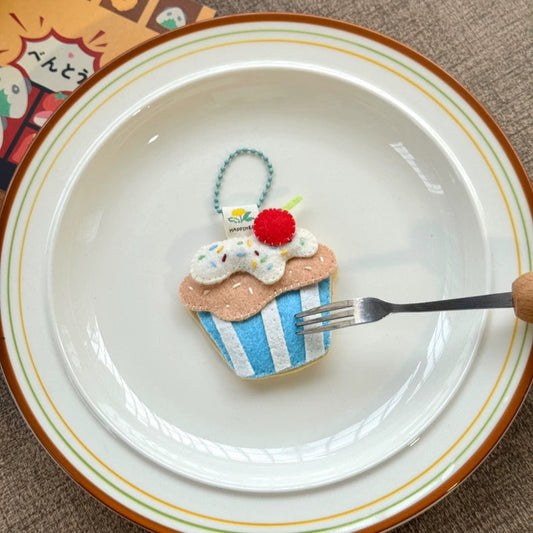 Cupcake-shaped cookie on a plate with a fork